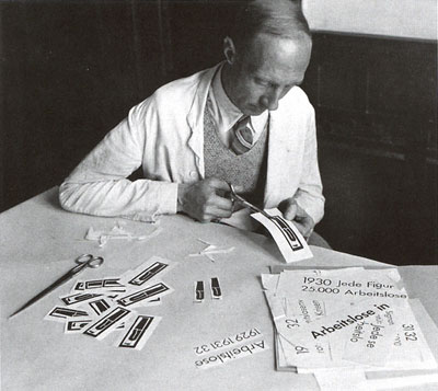 Assistant Skuravy cutting out linocut-printed symbols for assembly in a chart; about 1932